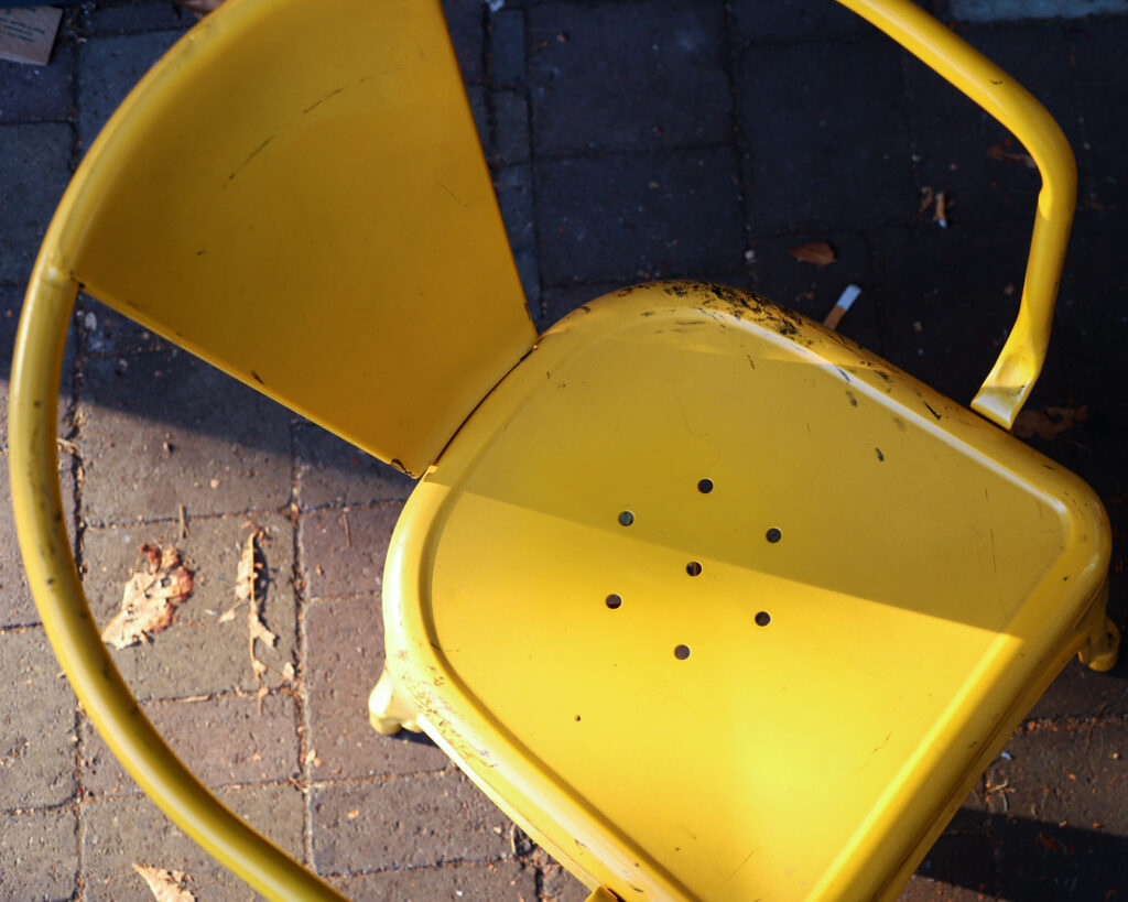 photo of yellow chair in half bathed in sunshine