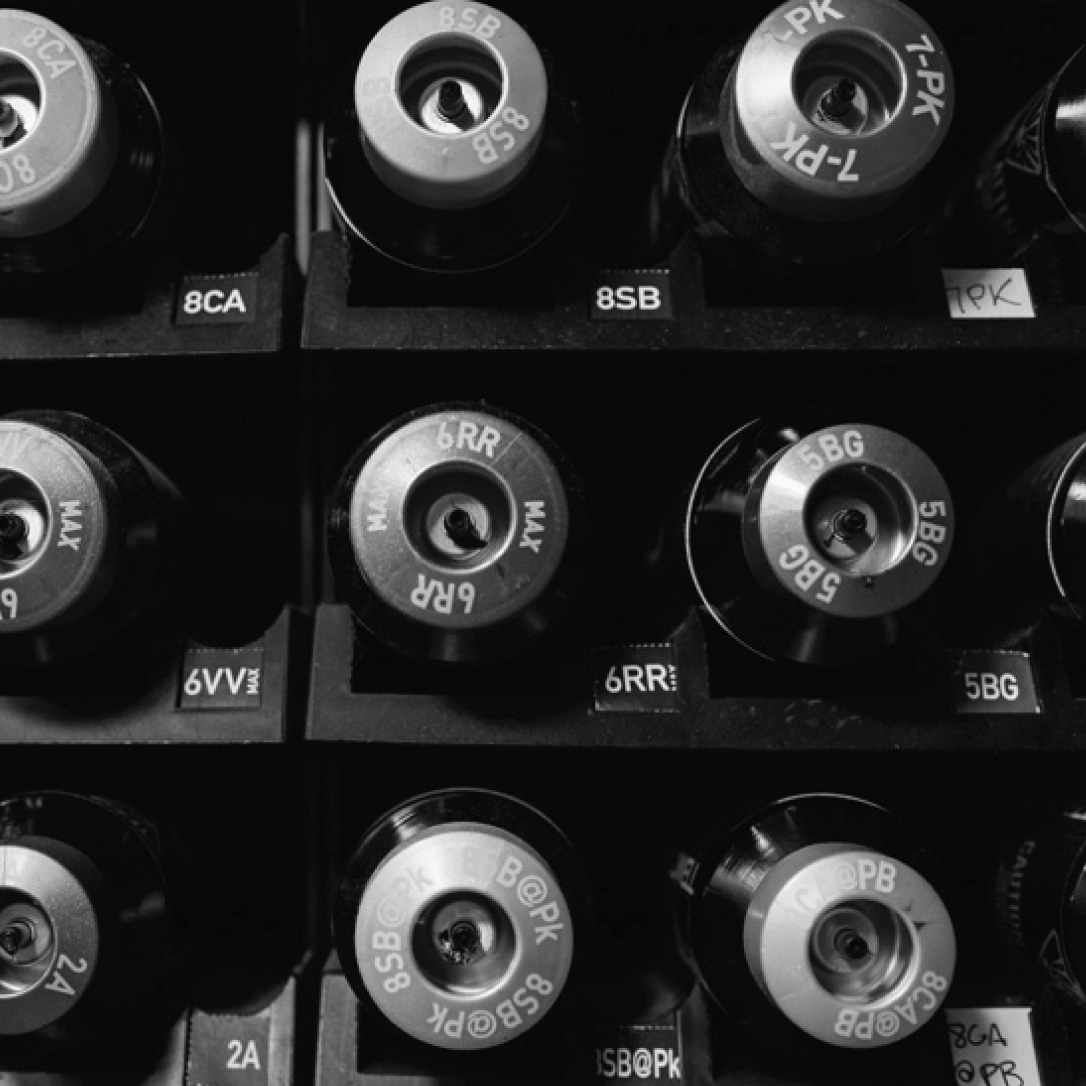 black and white photo of labeled cylinders on a shelf