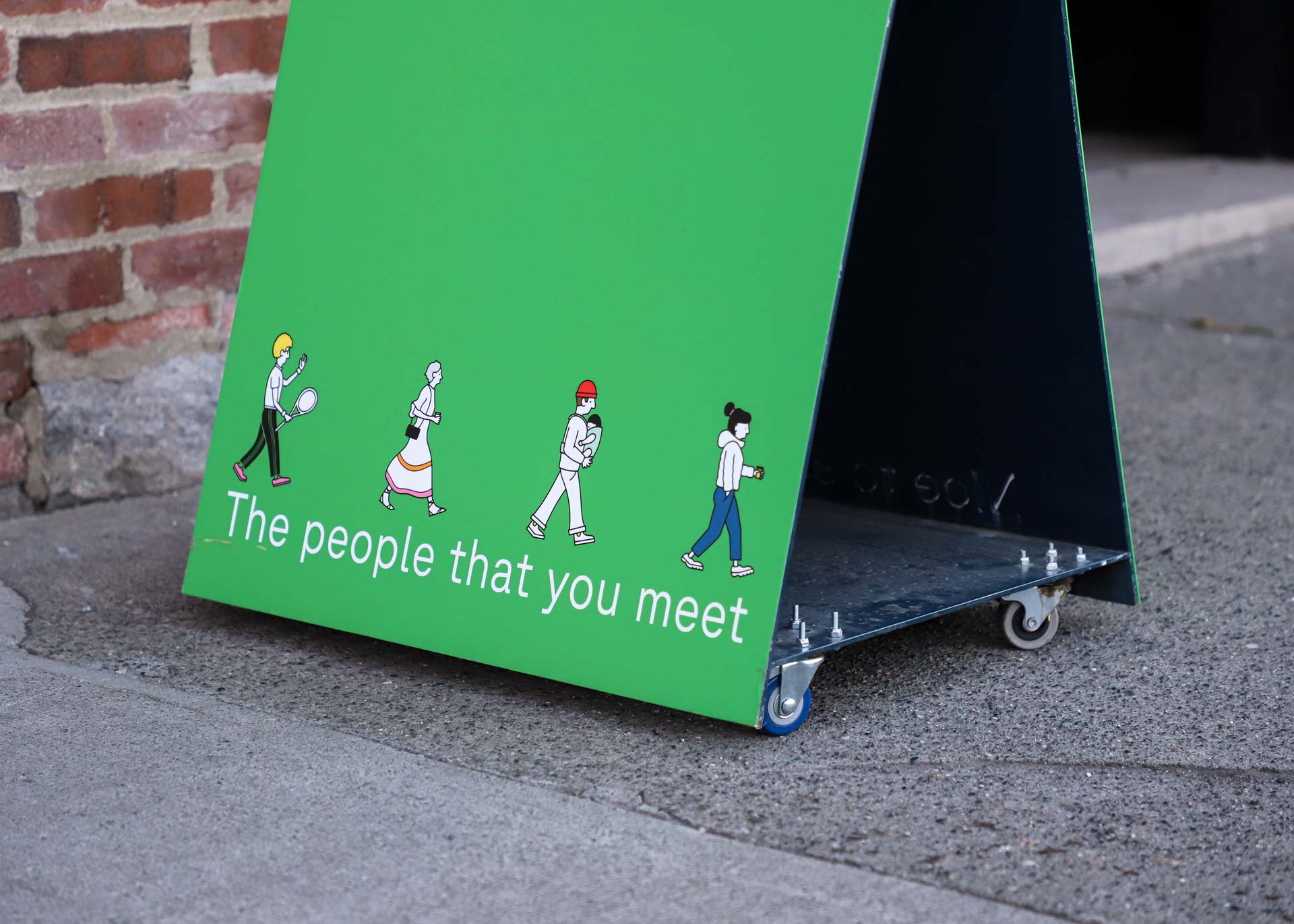 bright green sandwich board with illustrations and brand tagline