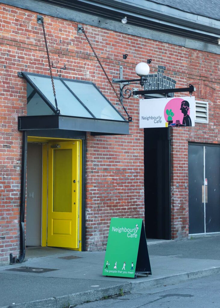 outdoor signage for a cafe in an industrial brick building