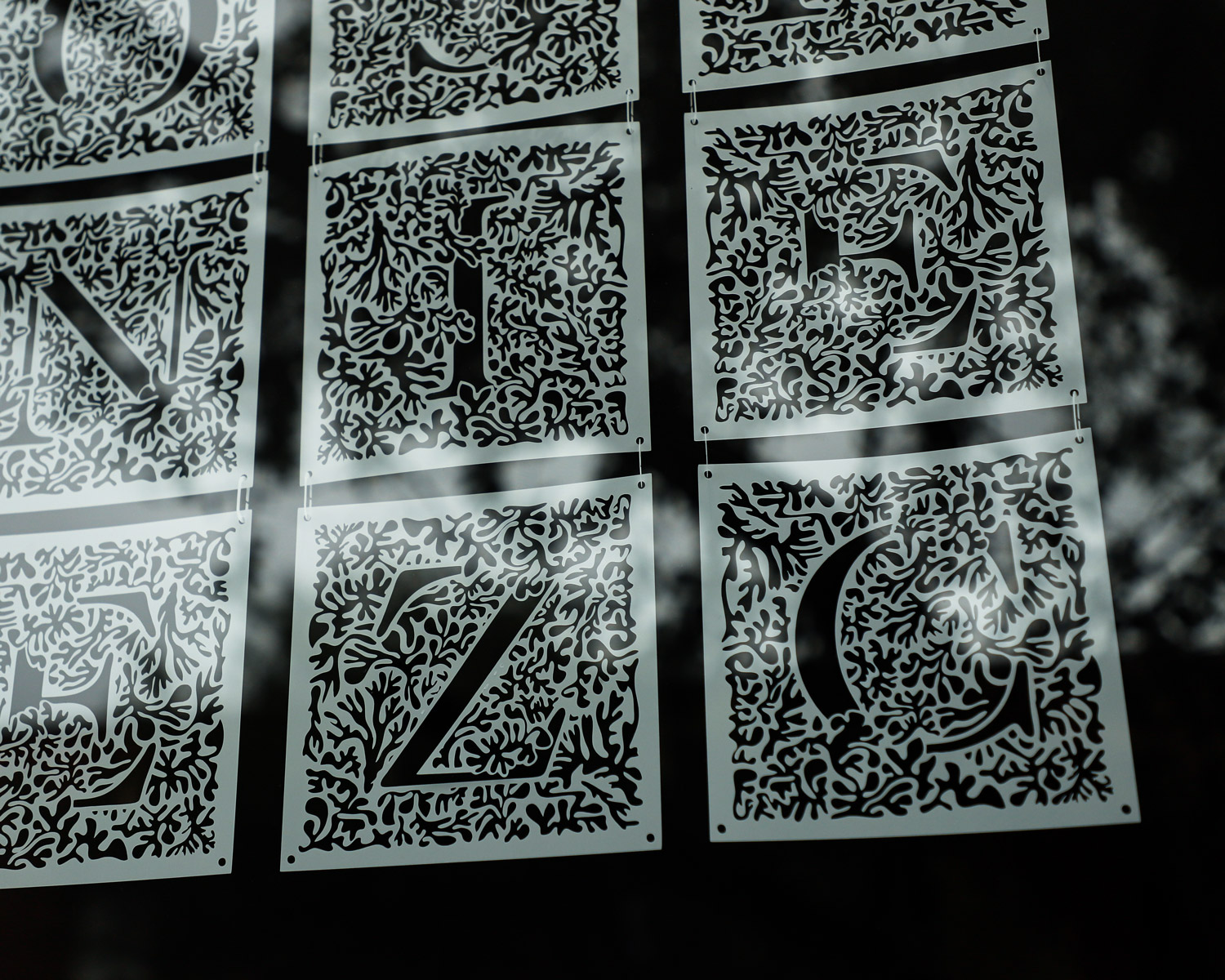 photo of custom typeface artwork hanging in a window